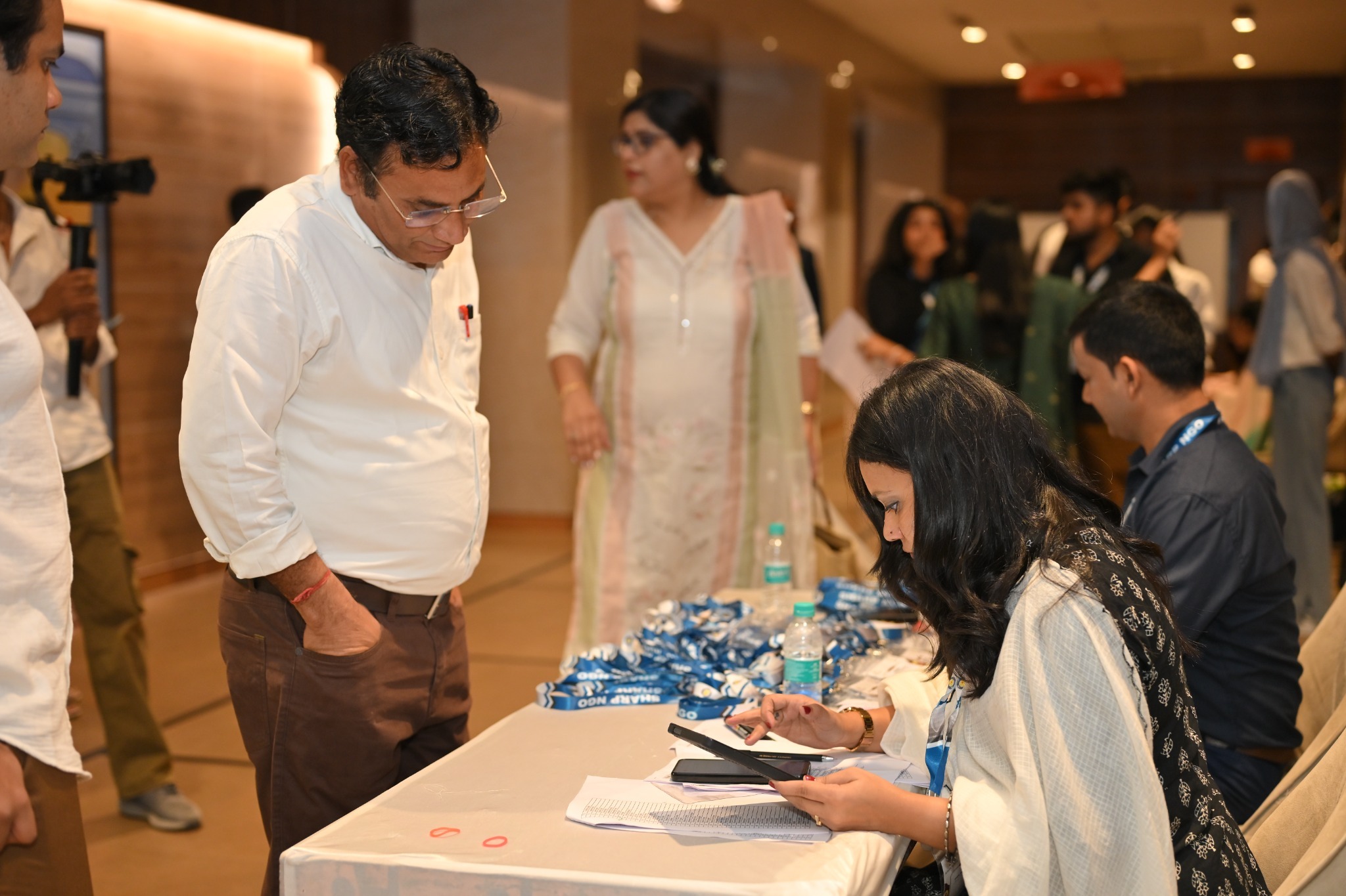 The registration team assists a delegate at the Rajasthan International Centre, Jaipur.